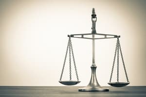A silver balance scale stands on a wooden surface against a plain, light-colored background, symbolizing justice, fairness, and the importance of public liability.